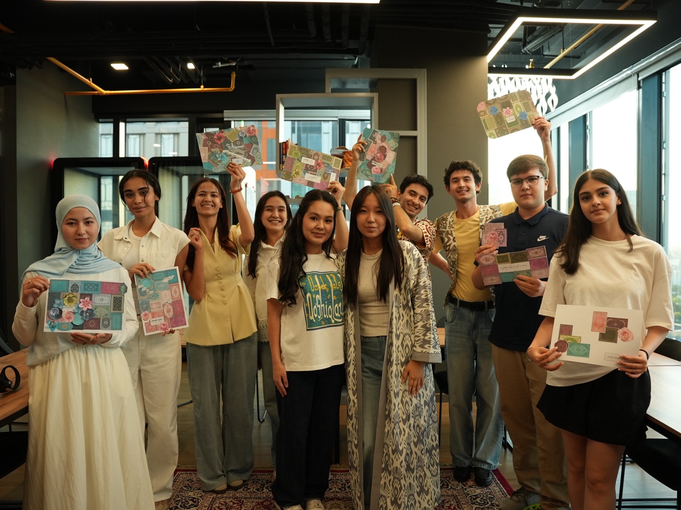 Freshman students holding up the collages they made