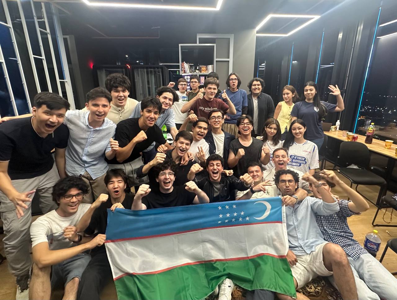 Freshman students cheering with the Uzbekistan flag